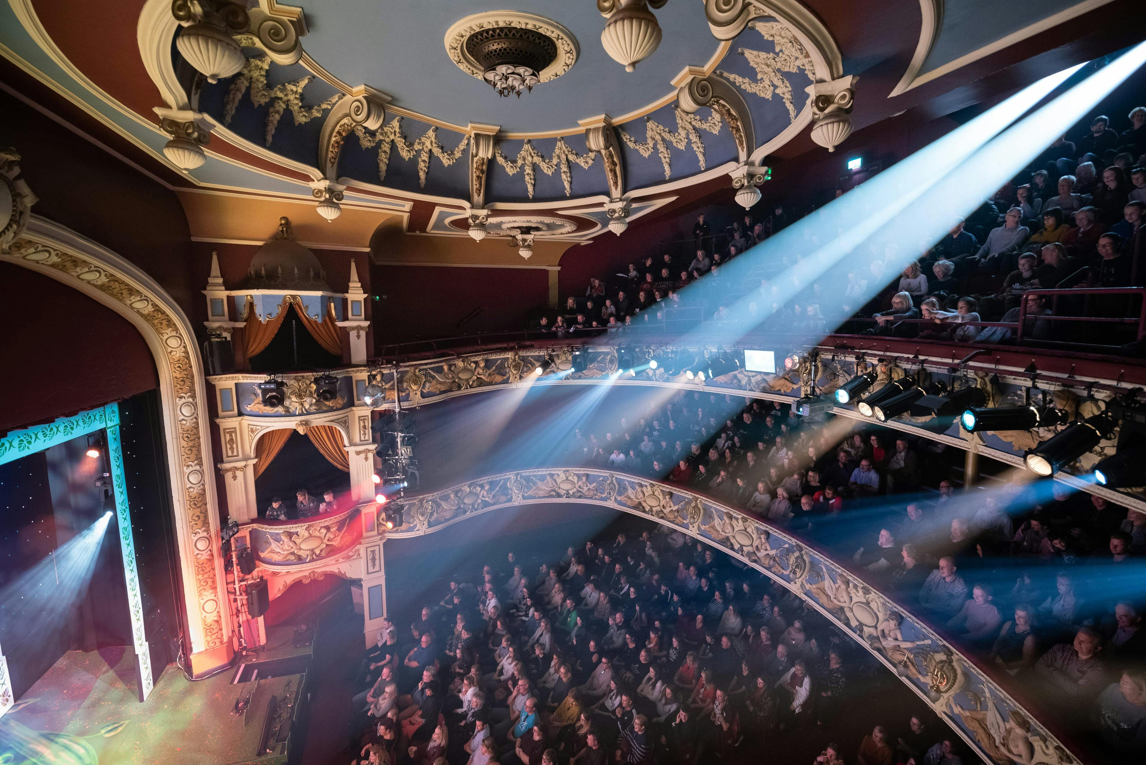 The Lyceum Theatre auditorium with spotlights and an audience sitting. 